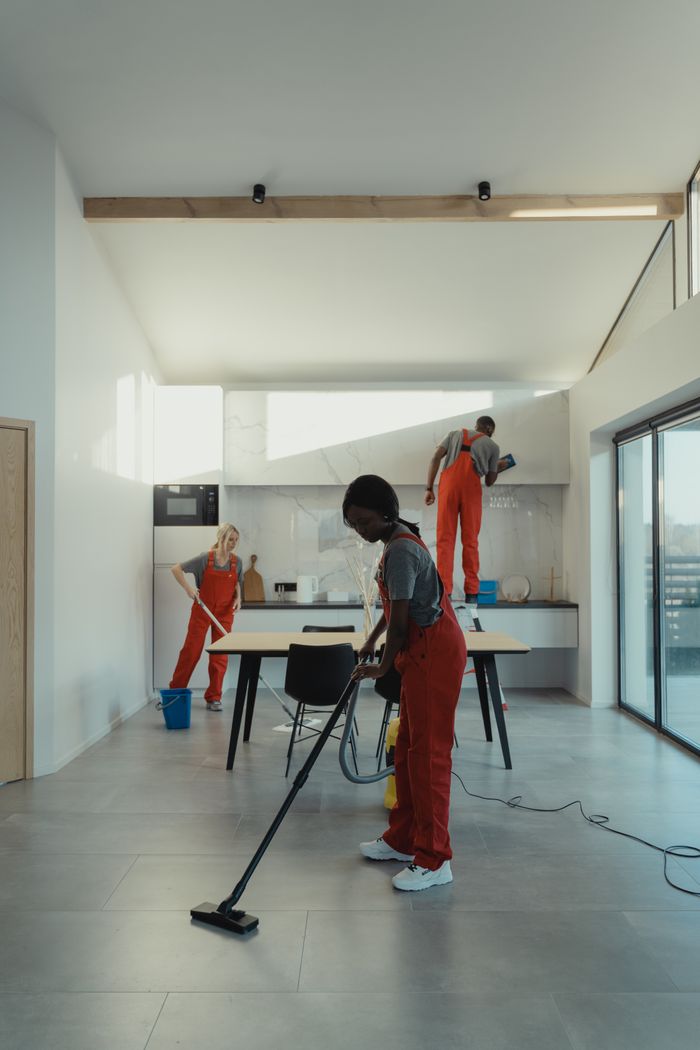 Mastering the First Impression: Your intriguing post title goes here A diverse group of professionals cleaning a modern home interior.
